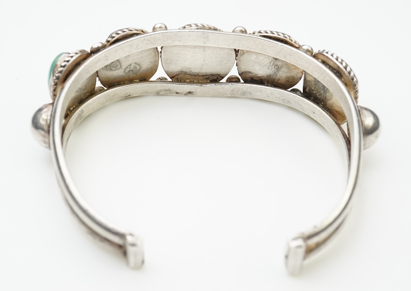 A collection of silver jewellery including a Zuni bangle